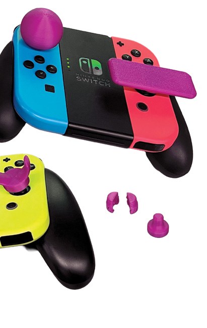 Nintendo Switch controllers with purple adaptive attachments, photographed by Vicki Karlovsky.