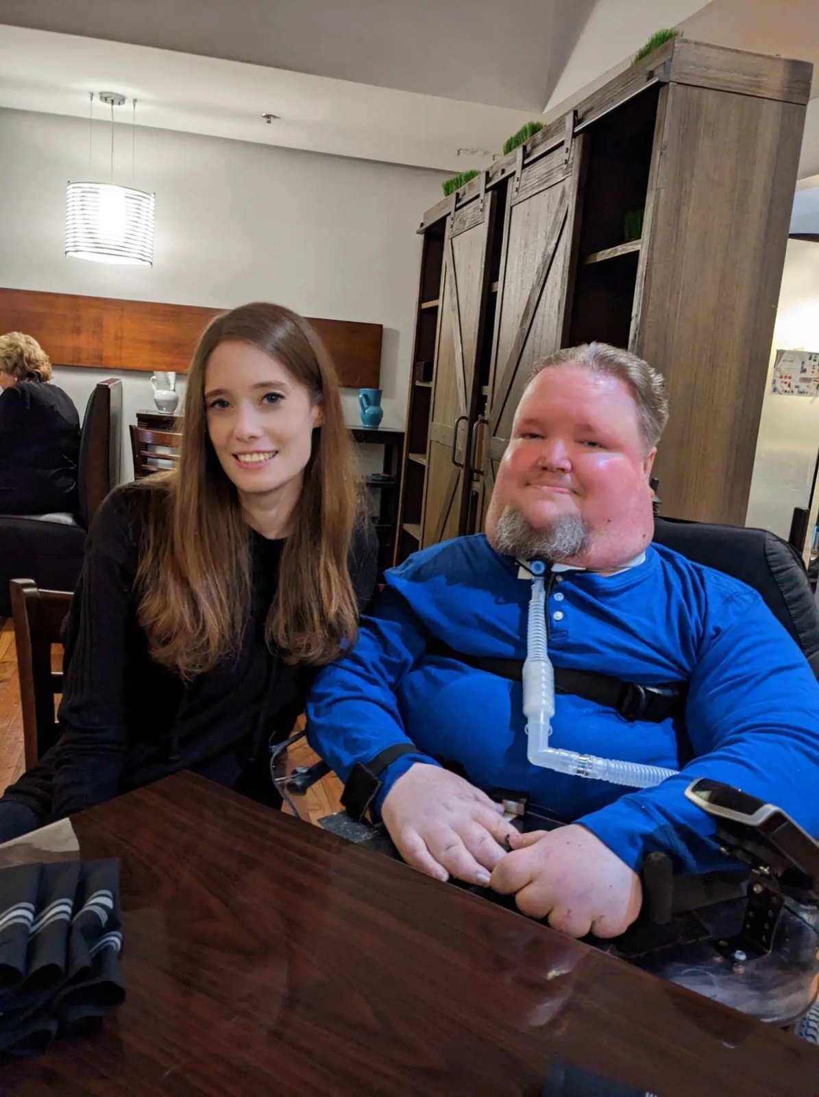 Steve Spohn and Vicki Karlovsky smiling together at a café.