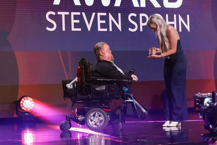 Steve on stage in his wheelchair at the 2022 Game Developers Choice Awards as he receives the Ambassador Award.