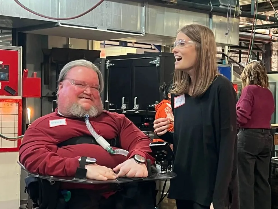 Steve and Vicki smiling together at a glassblowing studio.